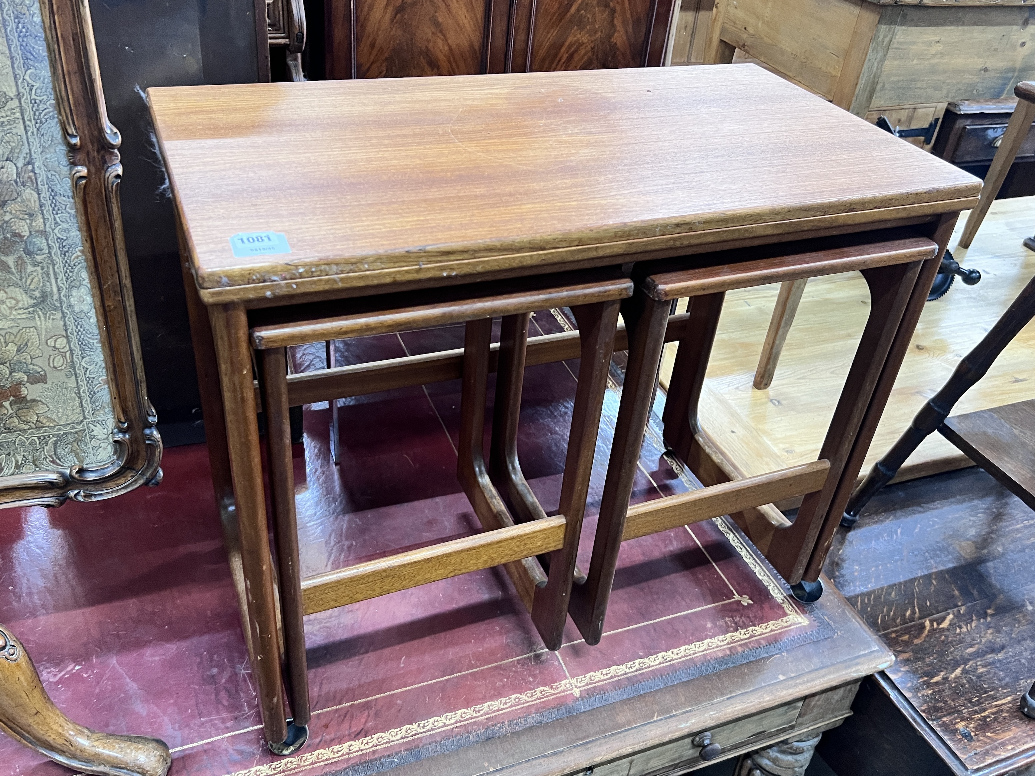 A nest of three G Plan teak tea tables with hinged swivel top, width 76cm, depth 40cm, height 64cm